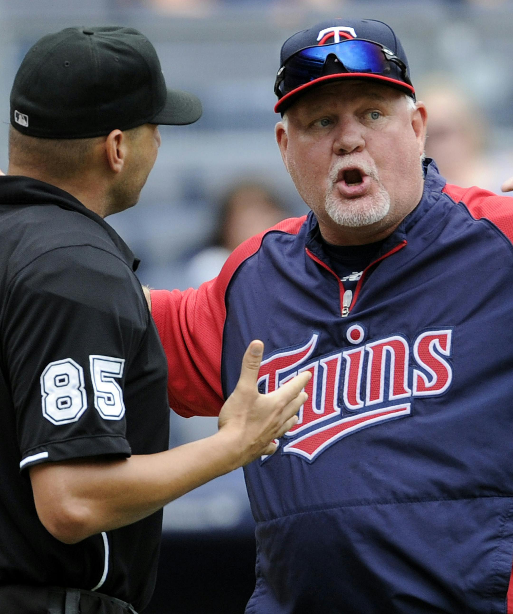 Minnesota Twins manager Ron Gardenhire argues with home plate umpire Vic Carapazza during the eighth inning of a baseball game against the New York Yankees Saturday, July 13, 2013, at Yankee Stadium in New York. (AP Photo/Bill Kostroun) ORG XMIT: MIN2013071315020305 ORG XMIT: MIN1307251943312573