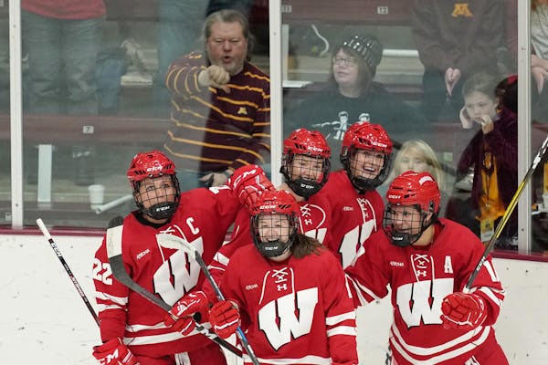 Wisconsin forward Daryl Watts (19) celebrated with teammates after she scored a goal at Ridder Arena in 2019 vs. the Gophers.