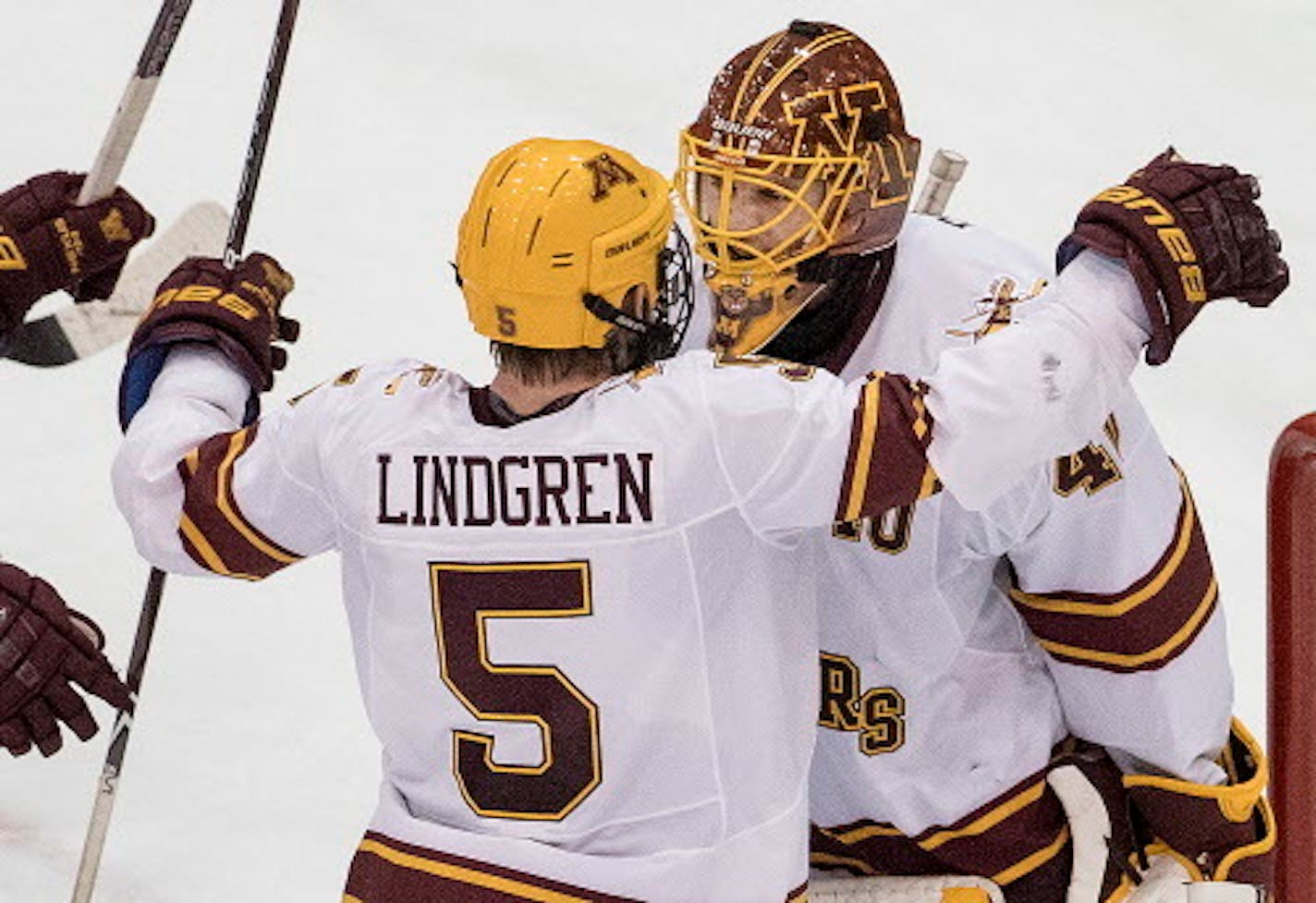 Ryan Lindgren (5) celebrated with Gophers goalie Mat Robson (40) at the end of the game. Robson had 34 saves in the 2-0 victory over St. Cloud State.