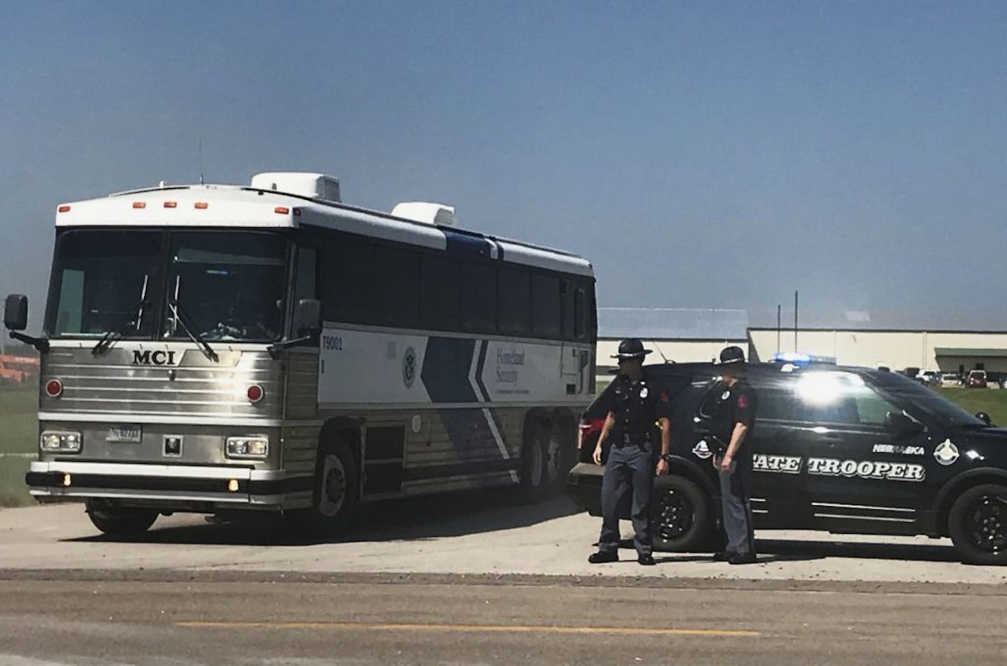 An ICE bus pulls out of a tomato plant in O'Neill, Neb., after an immigration raid at the plant Wednesday, Aug. 8, 2018. A large federal law enforcement operation conducted Wednesday targeted businesses in Nebraska and Minnesota that officials say knowingly hired - and mistreated - immigrants who are in the U.S. illegally.