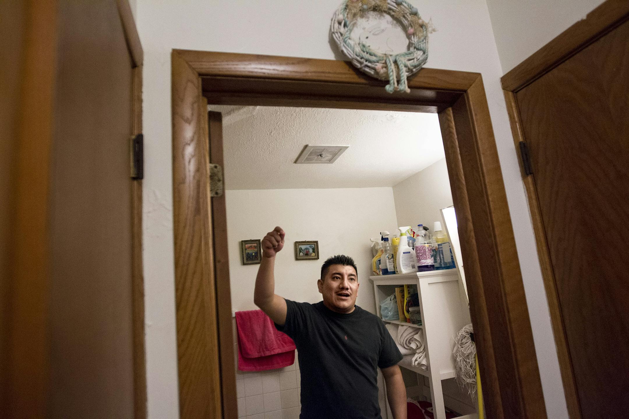 Tenant Jose Cruz Guzman points out ceiling mold left over from a water leak that was never fully repaired in his building on 22nd Avenue South in Minneapolis April 30, 2014. (Courtney Perry/Special to the Star Tribune)