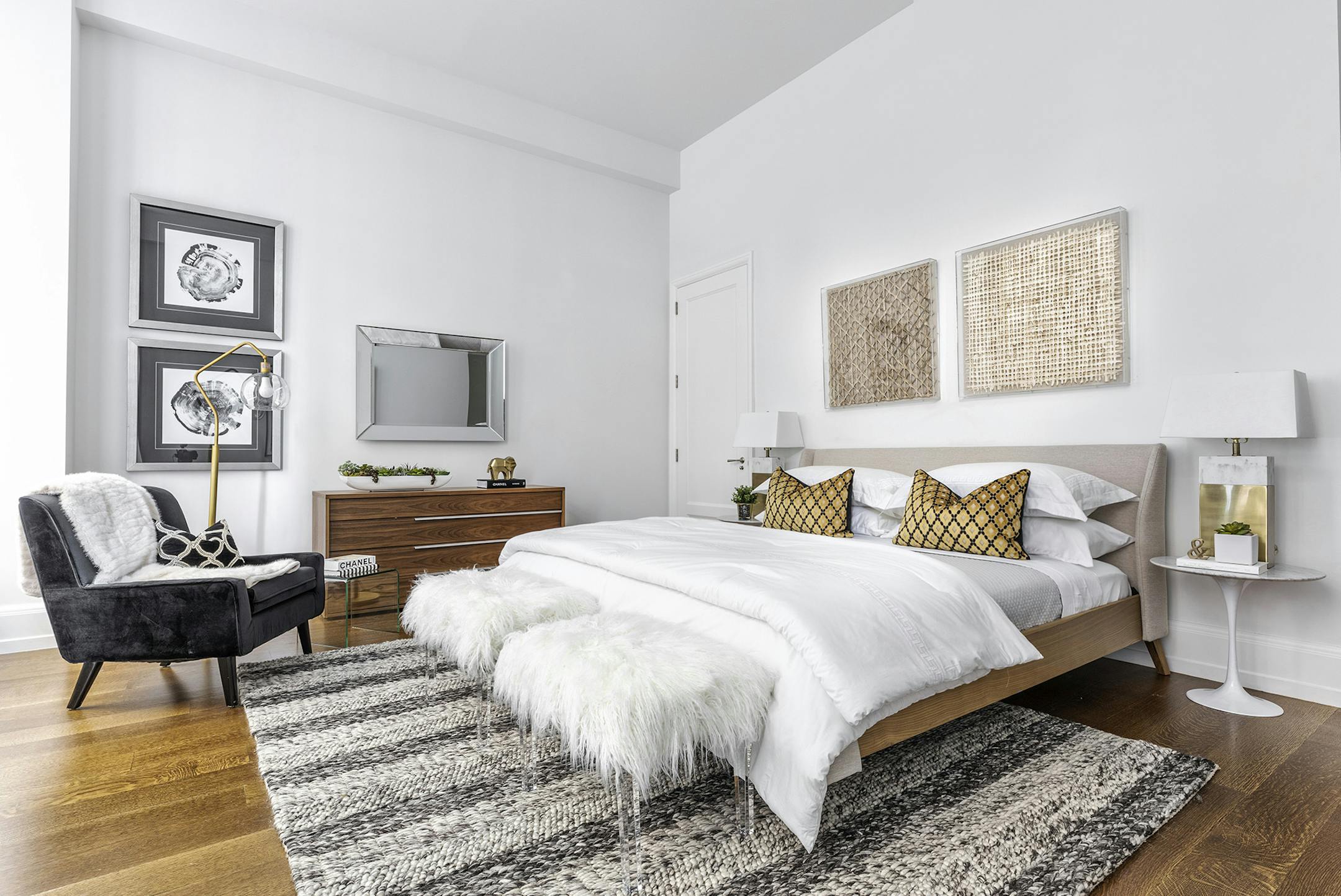 A master bed is elevated through a banded quilted coverlet placed on top of sheeting.