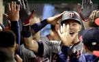 Minnesota Twins' Max Kepler celebrates in the dugout after his home run against the Los Angeles Angels during the sixth inning of a baseball game in A