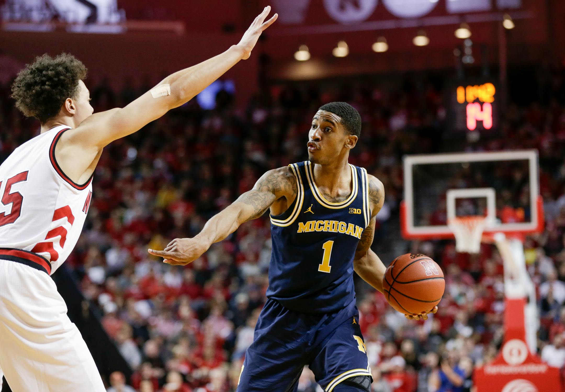 Michigan's Charles Matthews is defended by Nebraska's Isaiah Roby.