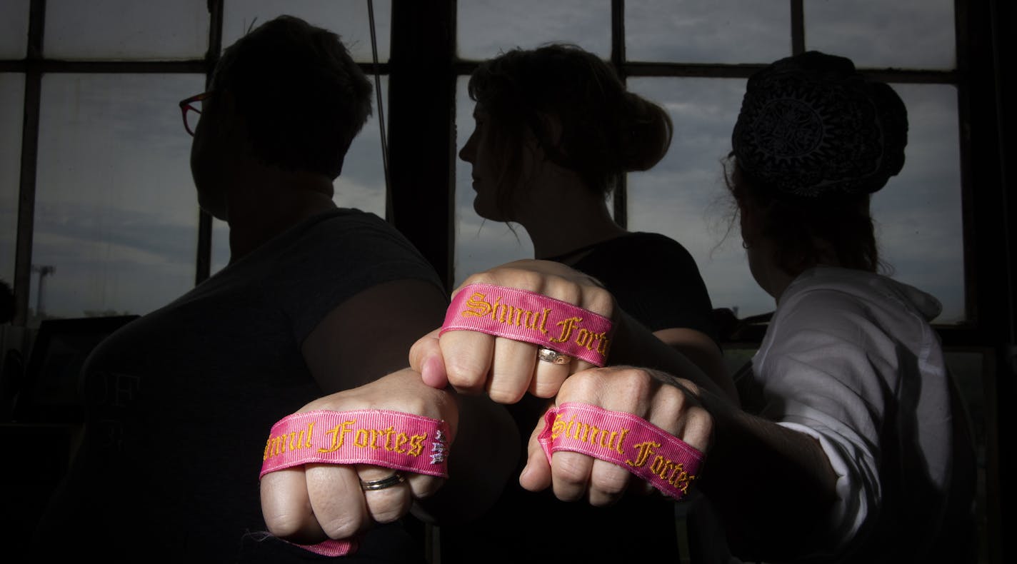 Shelley Wolf, Theresa Dorsey Meis, and Linda Clayton hold "Order of the Pink Garter" ribbons that administrators of the sisterhood facebook page wear on their arms while at the Renaissance Festival to indicate that they are safe people to talk to about harassment. Photographed in Minneapolis, Minn., on July 10, 2018. ] RENEE JONES SCHNEIDER &#xef; renee.jones@startribune.com