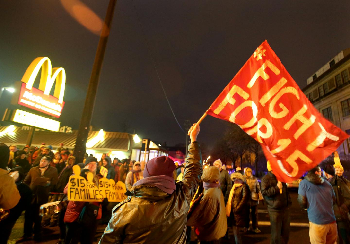 Protestors for Nationwide Fight for $15 Day of Disruption gathered outside McDonald's at 24th St. E. and Franklin Avenue, where for about a half hour protestors sat in a circle and blocked the intersection until they were arrested by Minneapolis police Tuesday, Nov. 29, 2016, in Minneapolis, MN. Here, a man who identified himself as Enrique holds a flag as protestors, not visible, sat nearby and blocked the intersection at 24th St. E. and Franklin Ave. before being taken into police custody. Tho