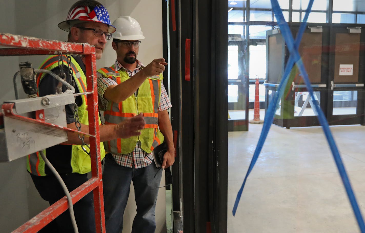 Rick Mickschl, left, and Isaac Stensland inspected work done on an addition at Humboldt High School last week in St. Paul.