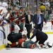 Medical personnel tend to Minnesota Wild defenseman Keith Ballard after he was injured on a check into the boards by New York Islanders left wing Matt