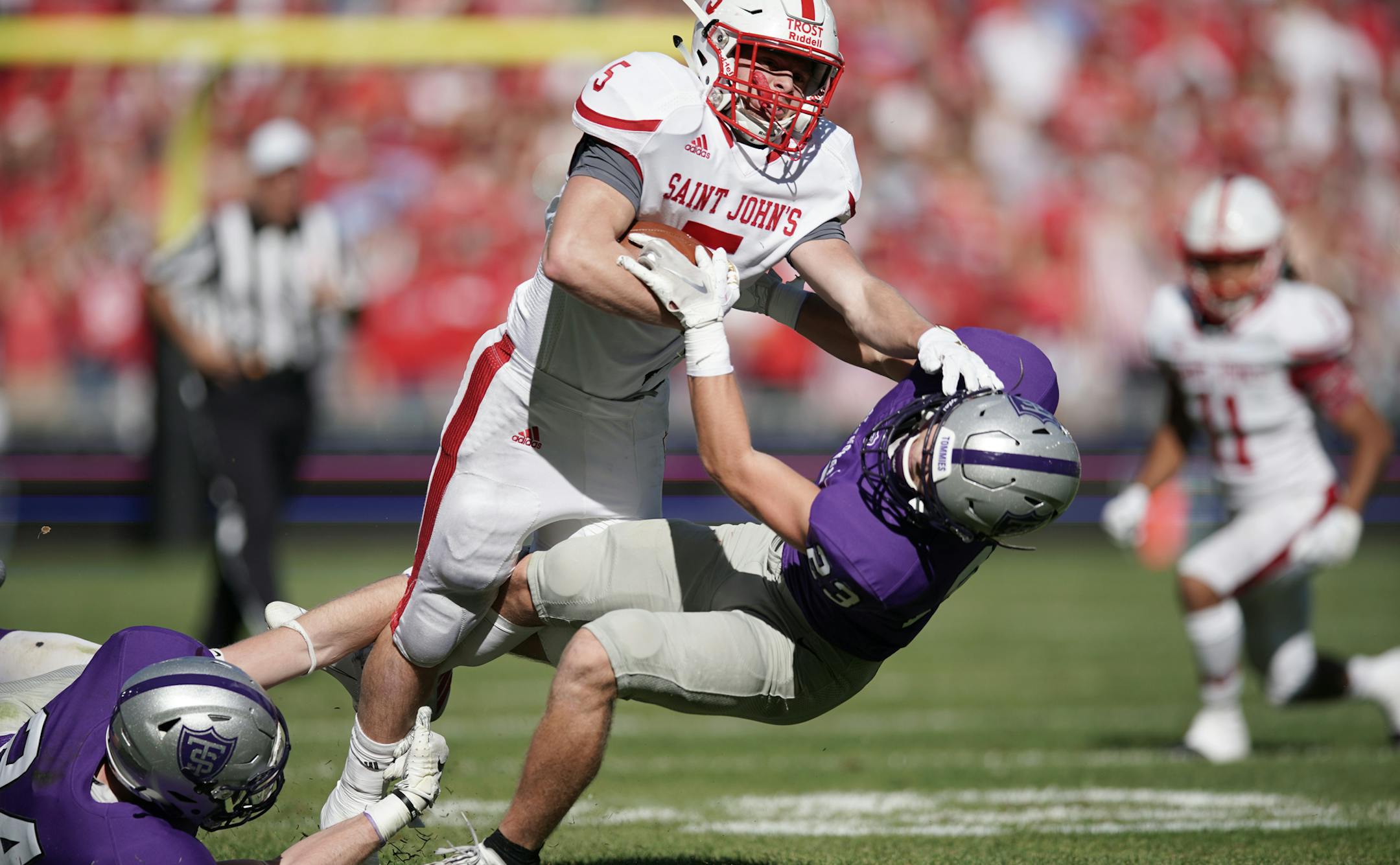 St. Thomas defensive back Luke Glenna (23) brought down St. John's running back Henry Trost (5). ] MARK VANCLEAVE ¥ St. John's University played the University of St. Thomas on Saturday, Oct. 19, 2019 at Allianz Field in St. Paul. St. John's defeated St. Thomas 38-20.