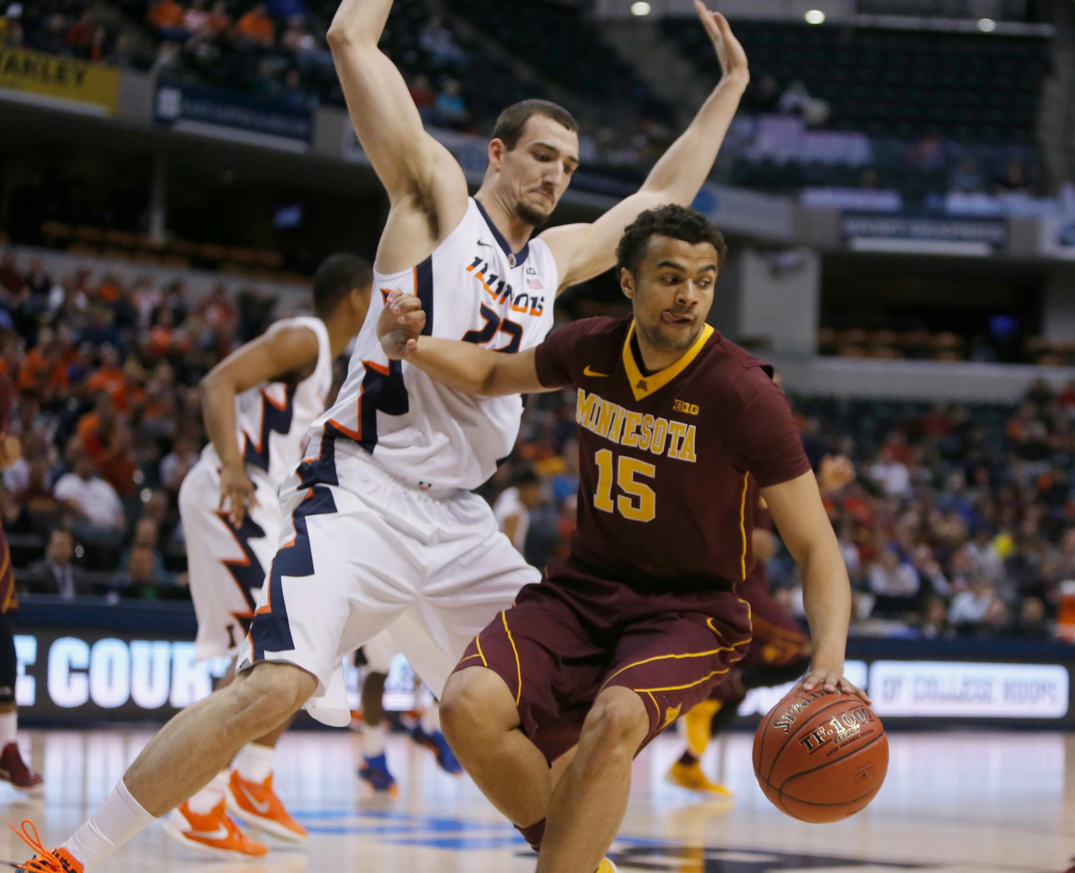 Minnesota's Stephon Sharp (15) drives against Illinois' Maverick Morgan (22) in the first half of an NCAA college basketball game at the Big Ten Conference tournament, Wednesday, March 9, 2016, in Indianapolis. (AP Photo/Kiichiro Sato)