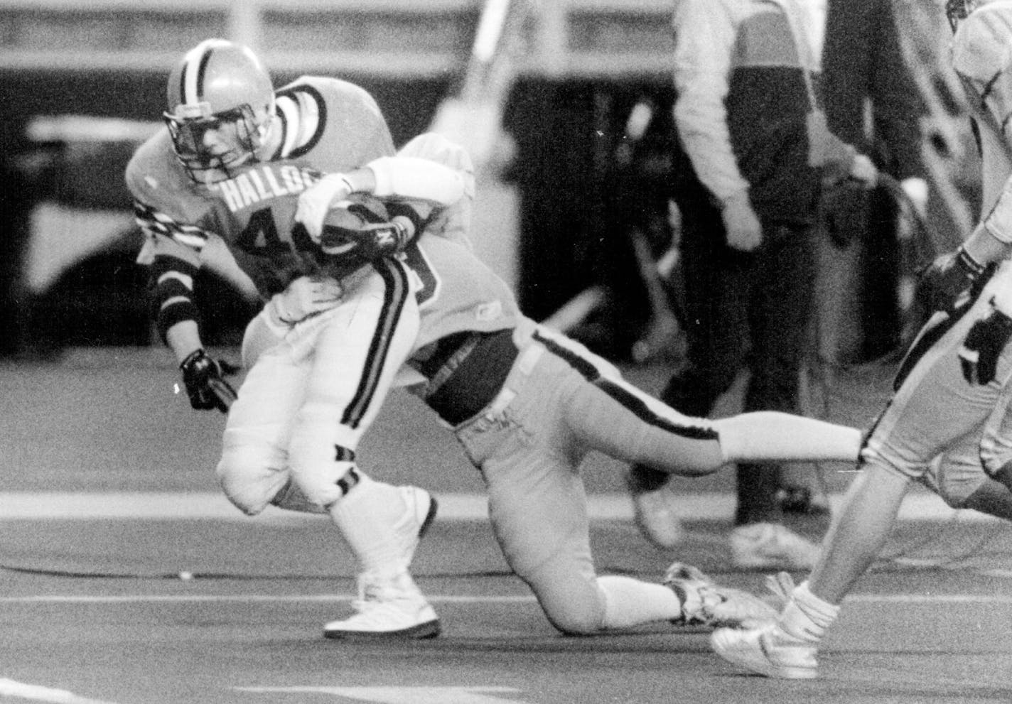 November 26, 1988 Metrodome... nine man game between stewart and hallock: #44 J T Anderson about to score a touchdown in the 4th quarter.. Hallock halfback J.T. Anderson dragged a Stewart defender across the goalline in the fourth quarter. November 27, 1988 Don Black, Minneapolis Star Tribune