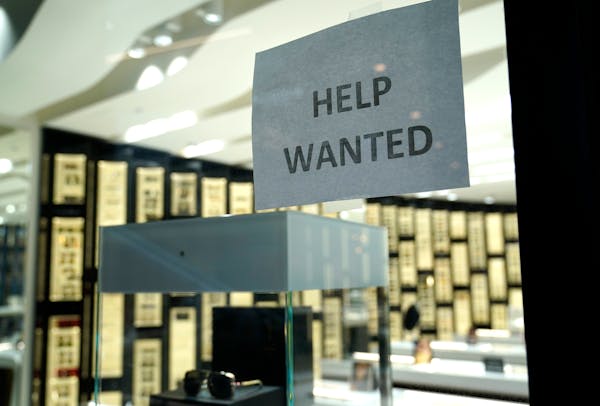 A Help Wanted sign is posted at a Designer Eyes store in Miami.