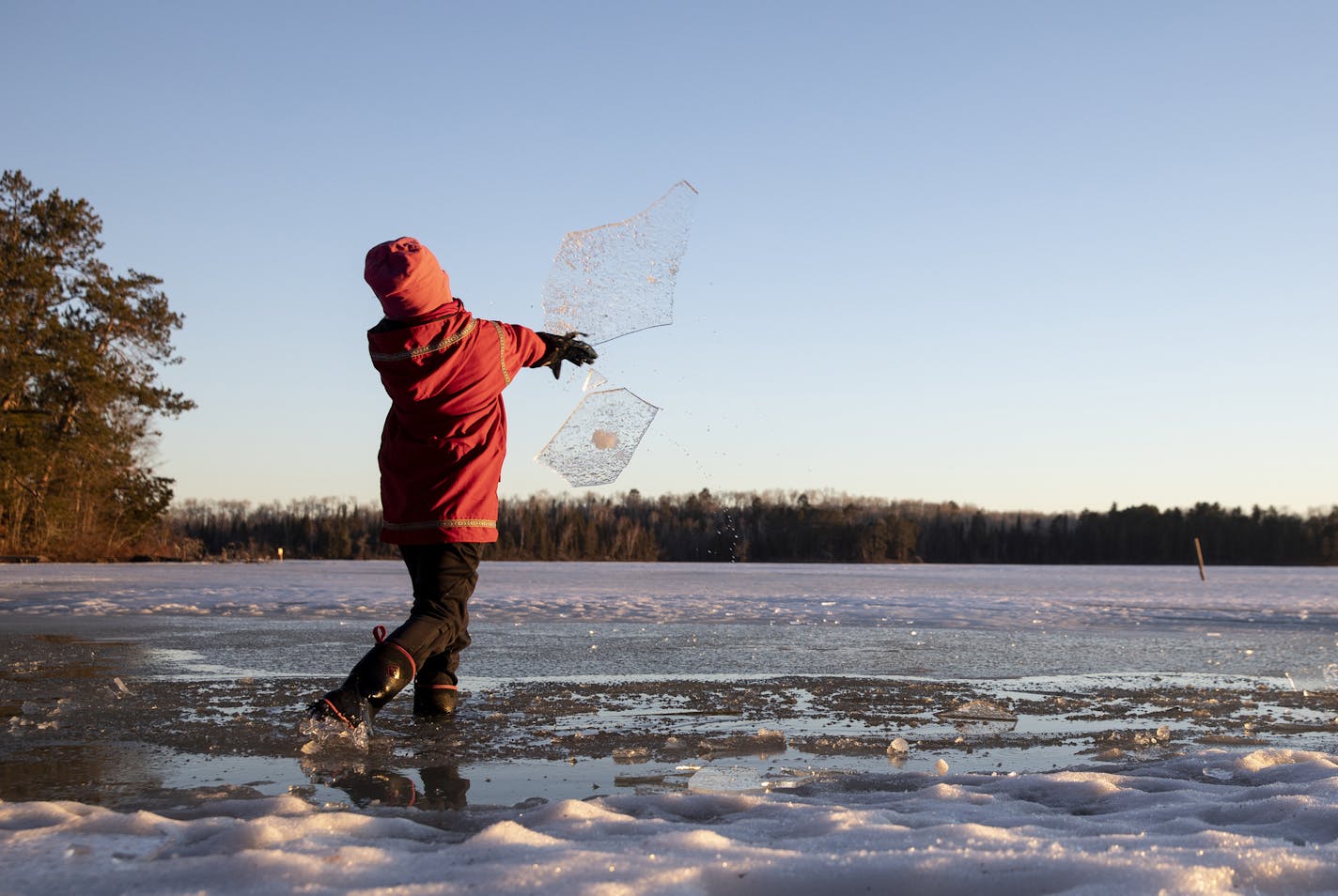 A boy played on the frozen lake at Wintergreen Dogsled Lodge outside of Ely, Minn., on Friday, April 19, 2019. New research, published on Wednesday, Nov. 18, 2020, in the journal PLoS One, on the connection between climate change and winter drownings has found that reported drowning deaths are increasing exponentially in areas with warmer winters.