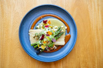 Spring vegetables top the tamal at Sooki & Mimi in Minneapolis.