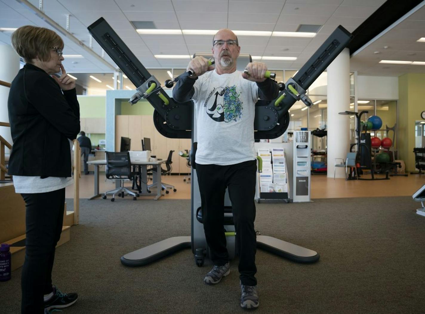 Heather Echert, of Champlin, watched her husband Phil Echert as he used a Health Access strength machine, a machine that keeps specific records on his progress, at the HealthPartners Neuroscience Center in St. Paul, Minn., on Tuesday, February 19, 2019. Phil was diagnosed with Alzheimers four years ago and the couple is part of a program for people with dementia and their caretakers to understand the connection between physical fitness and memory loss and dementia. "This place has been a godsend