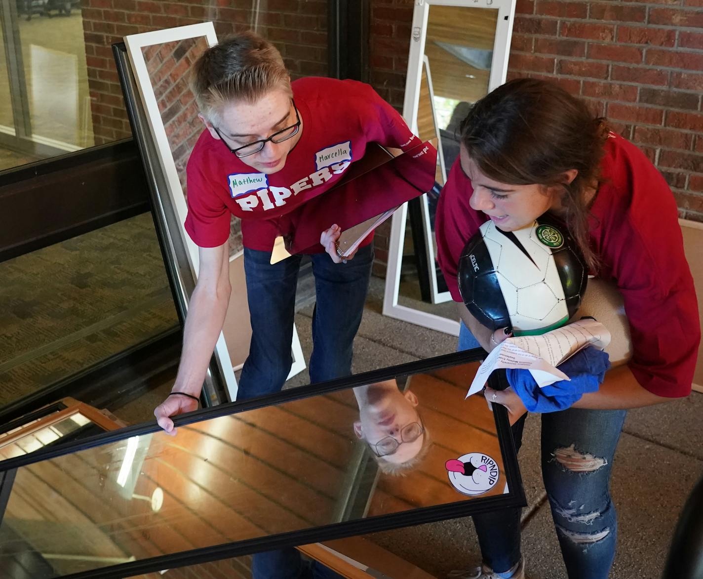 Freshmen Matthew Brady and Marcella Meneguzzi sorted through wall mirrors.