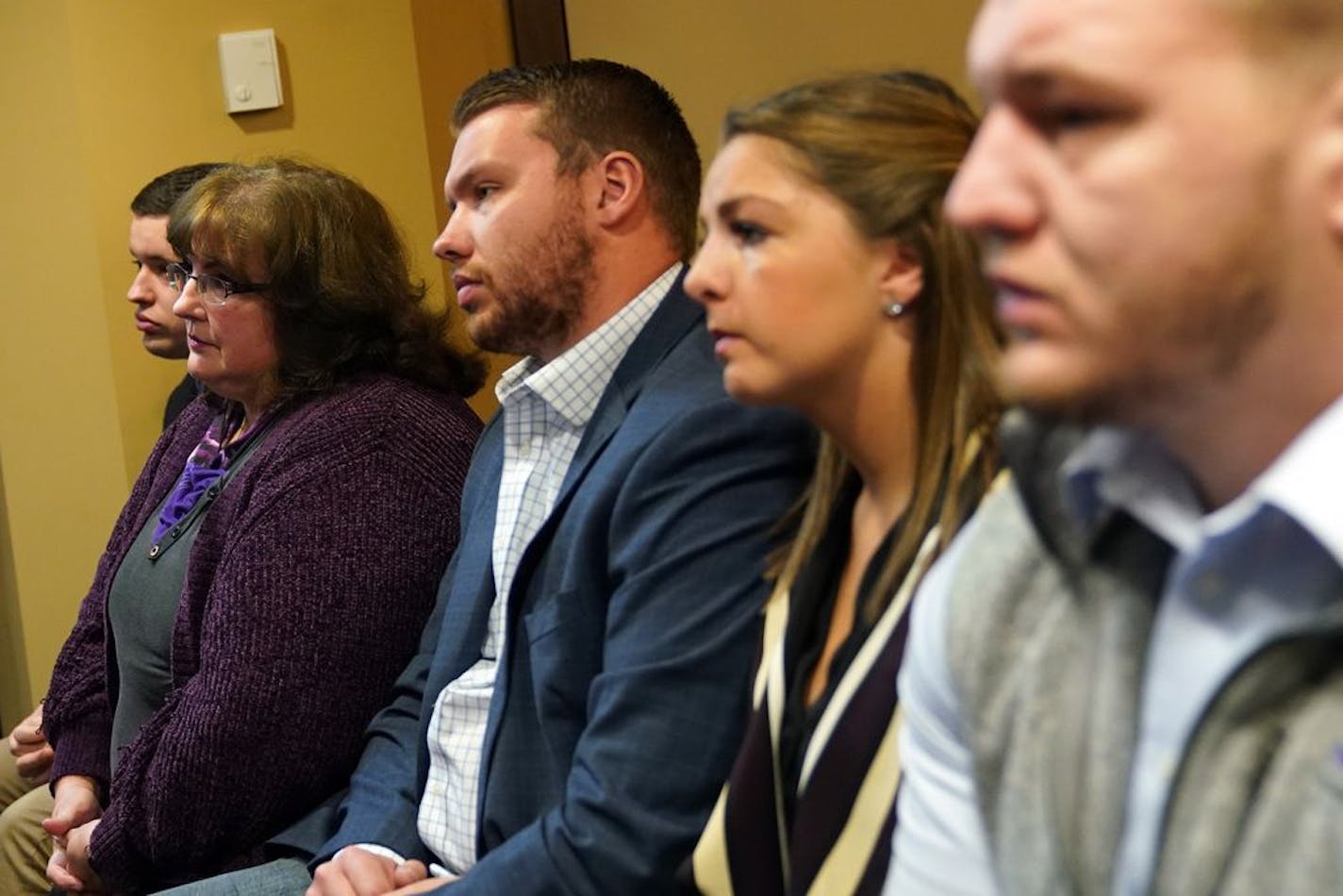 Joy Hoffman, second from left, sat with her sons who were victimized by former priest Curtis Wehmeyer, from left, Ben, Luke, Luke's wife Danielle, and Stephen during a press conference after submitting their final progress report on tightened clergy abuse protocols to a Ramsey County District judge Tuesday.