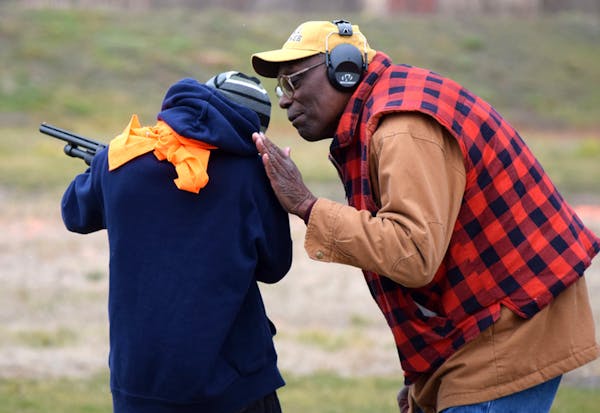 Thurman Tucker helped a young protegee at the South St. Paul Rod and Gun Club, teaching him and other kids firearms safety and how to shoot at clay ta