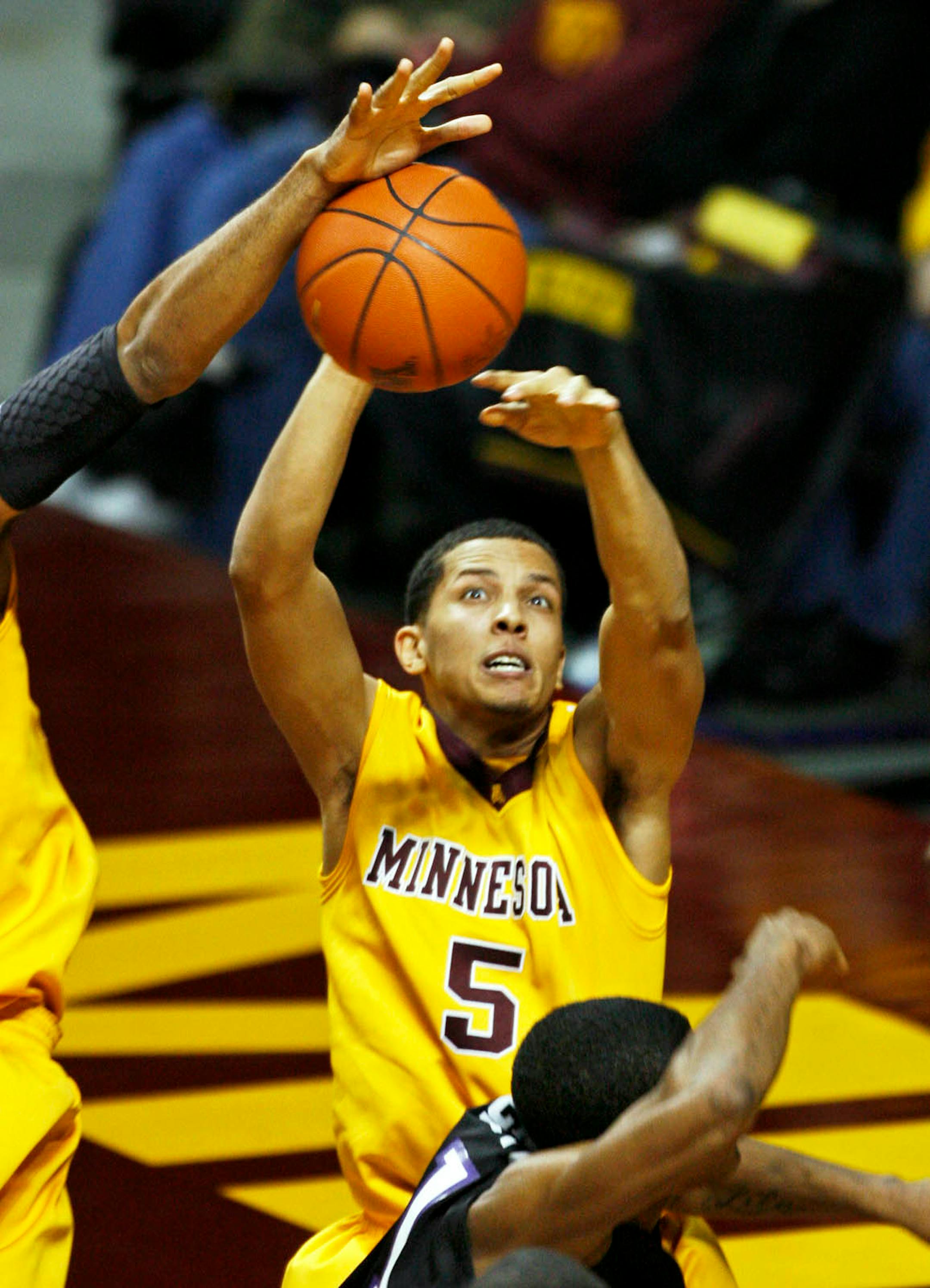 High Point's Nick Barbour had his shot blocked by the Gophers defense including Devoe Joseph (5).