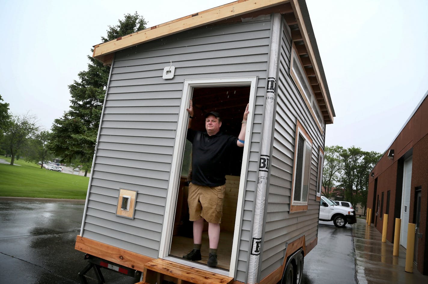 Brian Hurd posed inside a tiny house that was going to a homeless friend in Willmar. Across the country, cities have looked to tiny houses as possible answers to a number of problems.