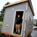Brian Hurd posed inside a tiny house that was going to a homeless friend in Willmar. Across the country, cities have looked to tiny houses as possible