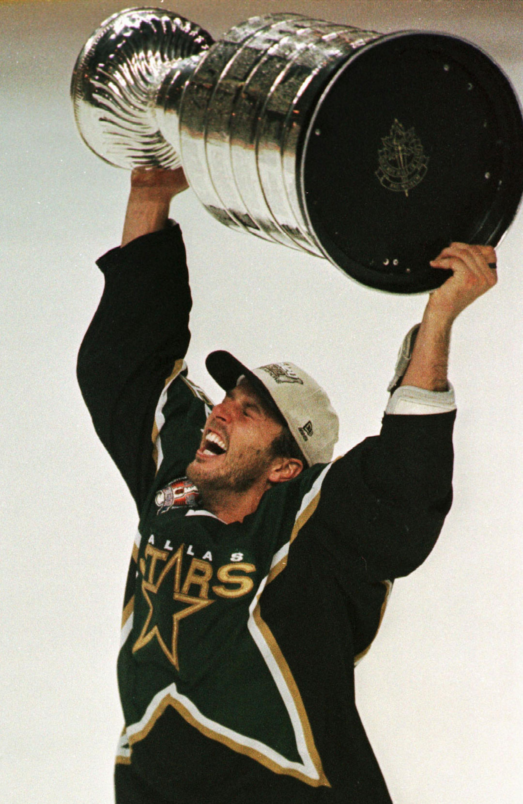 19 Jun 1999: Mike Modano #9 of the Dallas Stars skates with the Stanley Cup after game six of the NHL Stanley Cup Finals at Marine Midland Arena in Buffalo, New York. The Stars beat Buffalo 2-1 in triple overtime to win the Stanley Cup. Mandatory Credit: Ezra Shaw/ALLSPORT