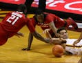 Gophers center Reggie Lynch, right, reached for a loose ball along with Rutgers' Mamadou Doucoure (21) and Mike Williams (5) in the first half Sunday.