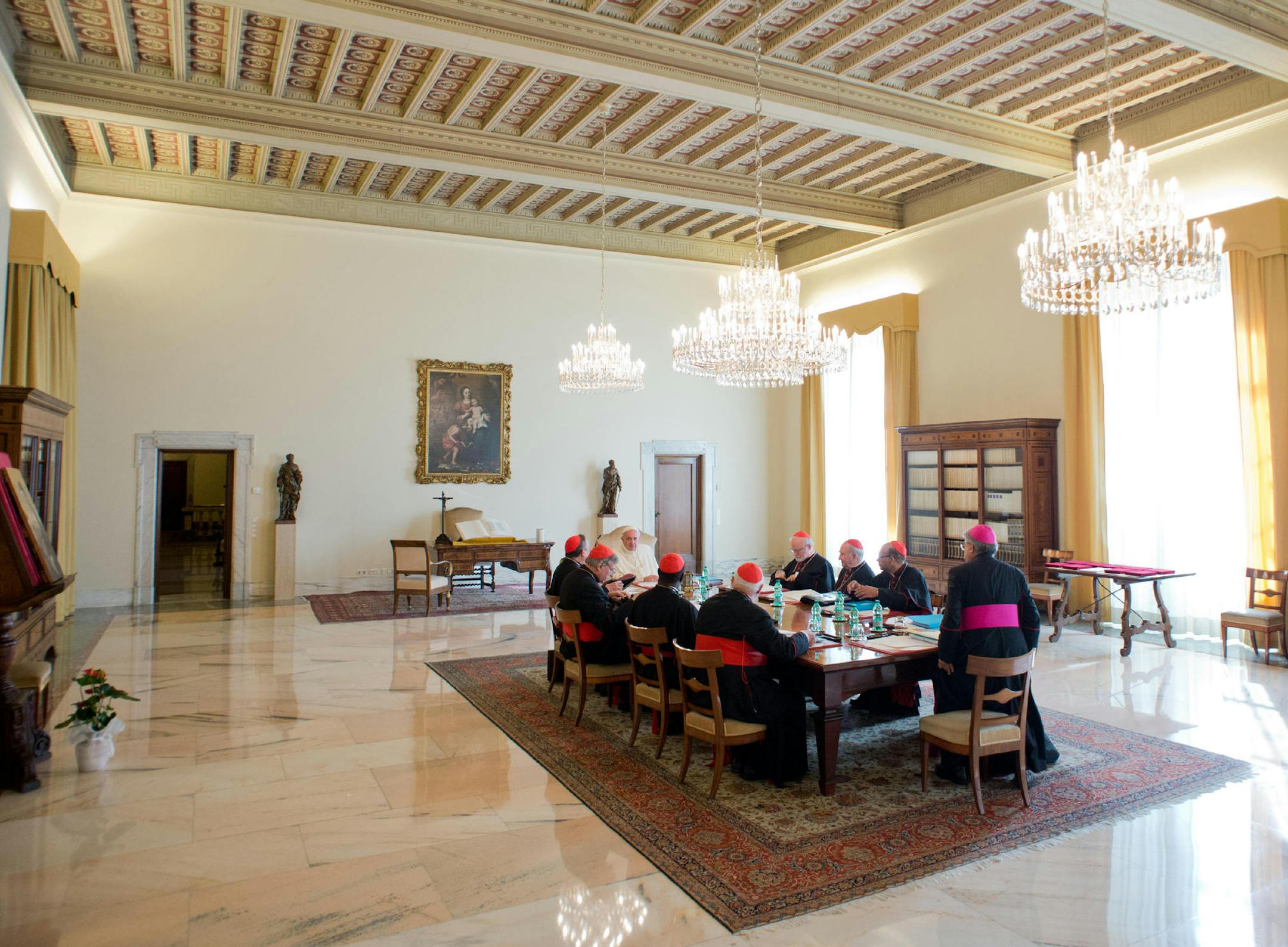 In this picture provided Tuesday, Oct. 1, 2013, by the Vatican newspaper L'Osservatore Romano, Pope Francis sits with his so-called "Group of Eight" cardinals, during their first meeting at the Vatican. Pope Francis convened his parallel cabinet on Tuesday for a first round of talks on reforming the Catholic Church, bringing eight cardinals from around the globe together in a novel initiative to get local church leaders involved in helping make decisions for the 1.2-billion strong universal Cath