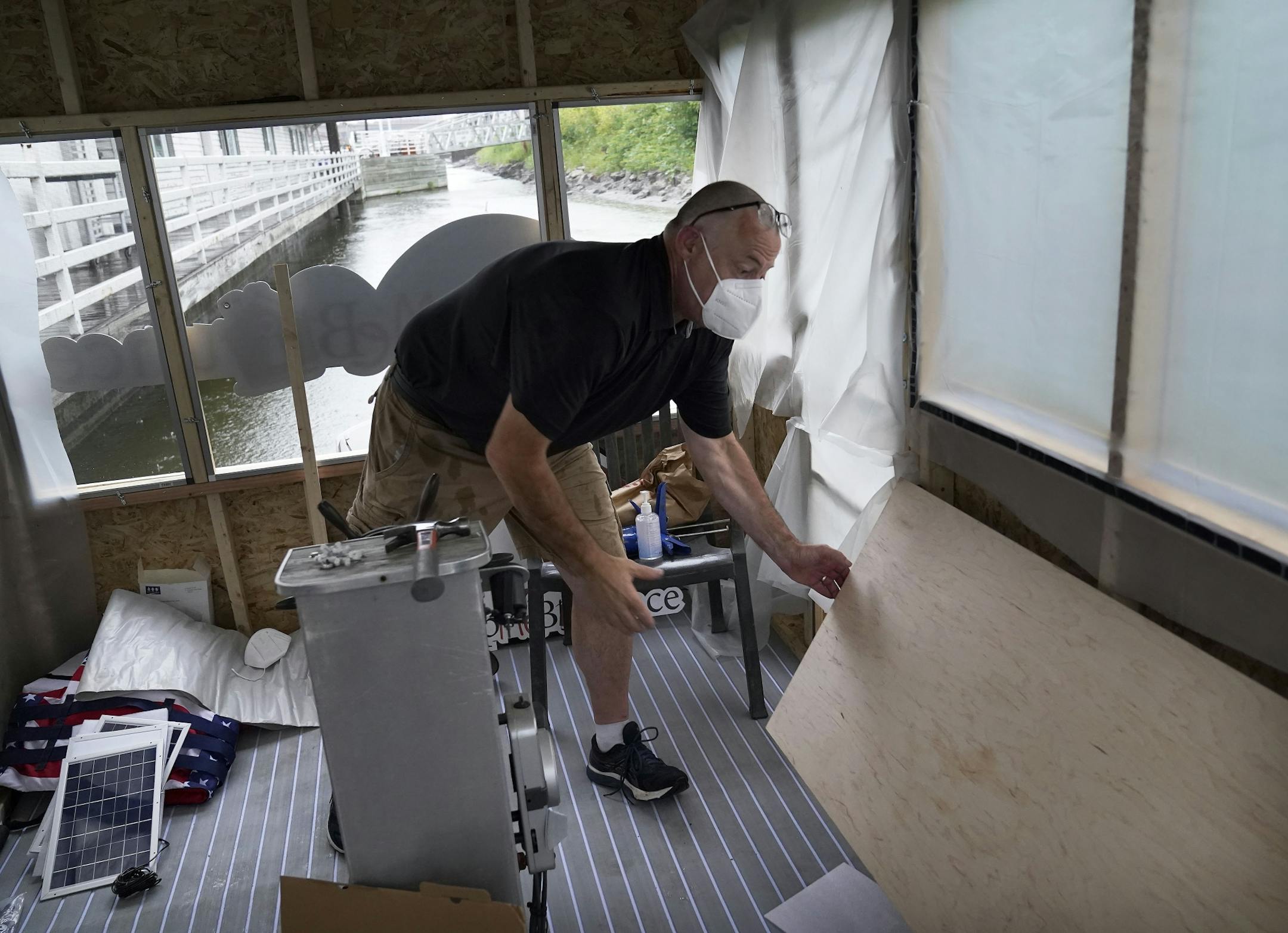 Erich Mische, executive director of Spare Key, will begin on Aug. 27, a two-month, 1,700 mile journey down the Mississippi River to Baton Rouge, LA, on a raft in order to raise funds for his non-profit and keep it afloat. Here, Mische is seen on the small raft, built upon a small pontoon, docked and being prepared on Harriet Island for the launch Wednesday in St. Paul.