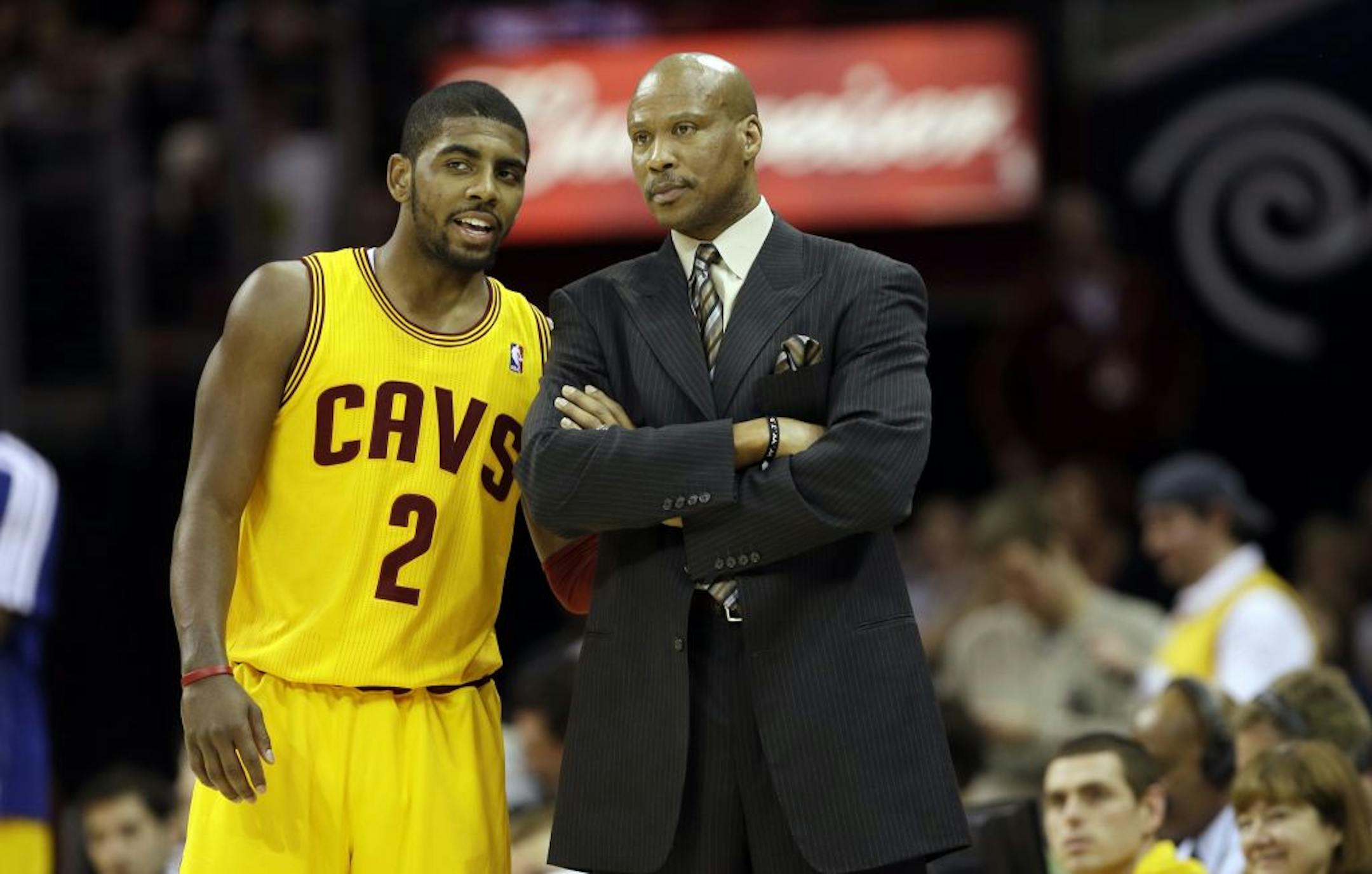 Cleveland Cavaliers' Kyrie Irving (2)talks with head coach Byron Scott during an NBA basketball game against the Milwaukee Bucks Friday, Jan. 25, 2013, in Cleveland.