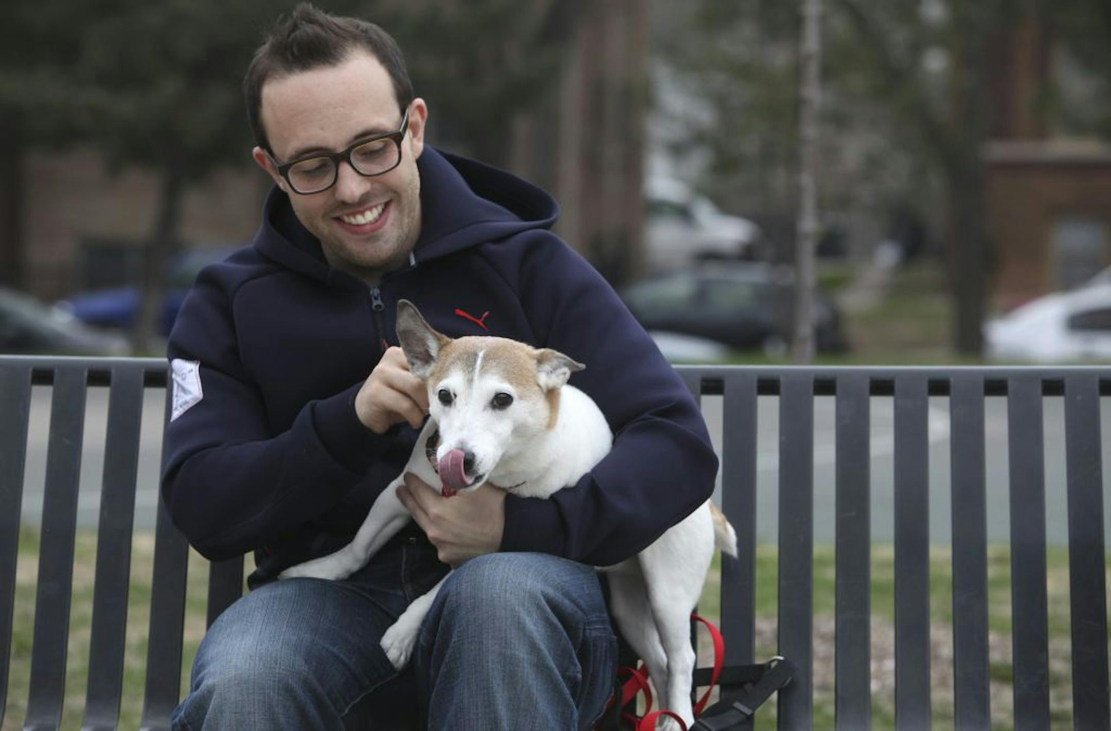 Michael Abata held his dog Jake, a 10 year-old Jack Russell terrier, across the street for his home in Minneapolis, Min., Saturday, March 31, 2012. . Abata and his ex John Peterson have worked out shared custody of Jake.