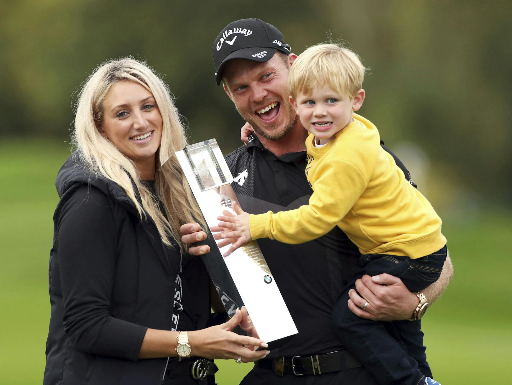 England's Danny Willett, his wife Nicole and son Zachariah James pose with the trophy after winning the PGA Championship at Wentworth Golf Club, Wentworth, England, Sunday Sept. 22, 2019. (Bradley Collyer/PA via AP)