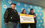 Dennis Kujawa (from left), his daughter, Denise, and his sister, Debbie, show off their lottery winnings. In a lump sum, after taxes, the family membe