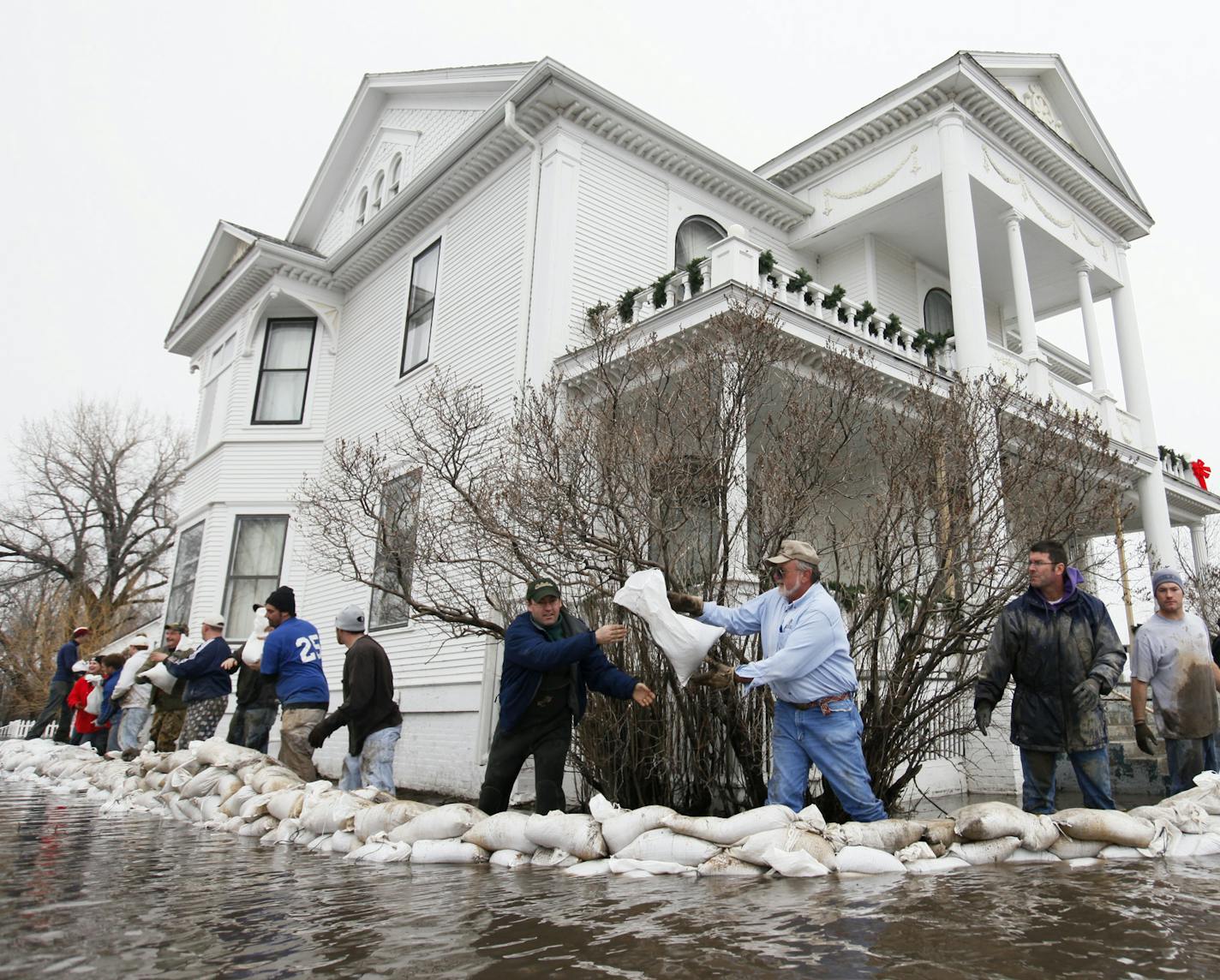 Richard Tsong-Taatarii/rtsong-taatarii@startribune.com On the corner of Hwy 75N/100 Ave N. outside of Moorhead, Minn., at the home of Jeremy Kuipers. Friends and volunteers helped shore up the defenses against the rising waters. Located at afriendshouse.info. The home built in 1902 is on the historic register. (Pioneer Press OUT Twin Cities television OUT)