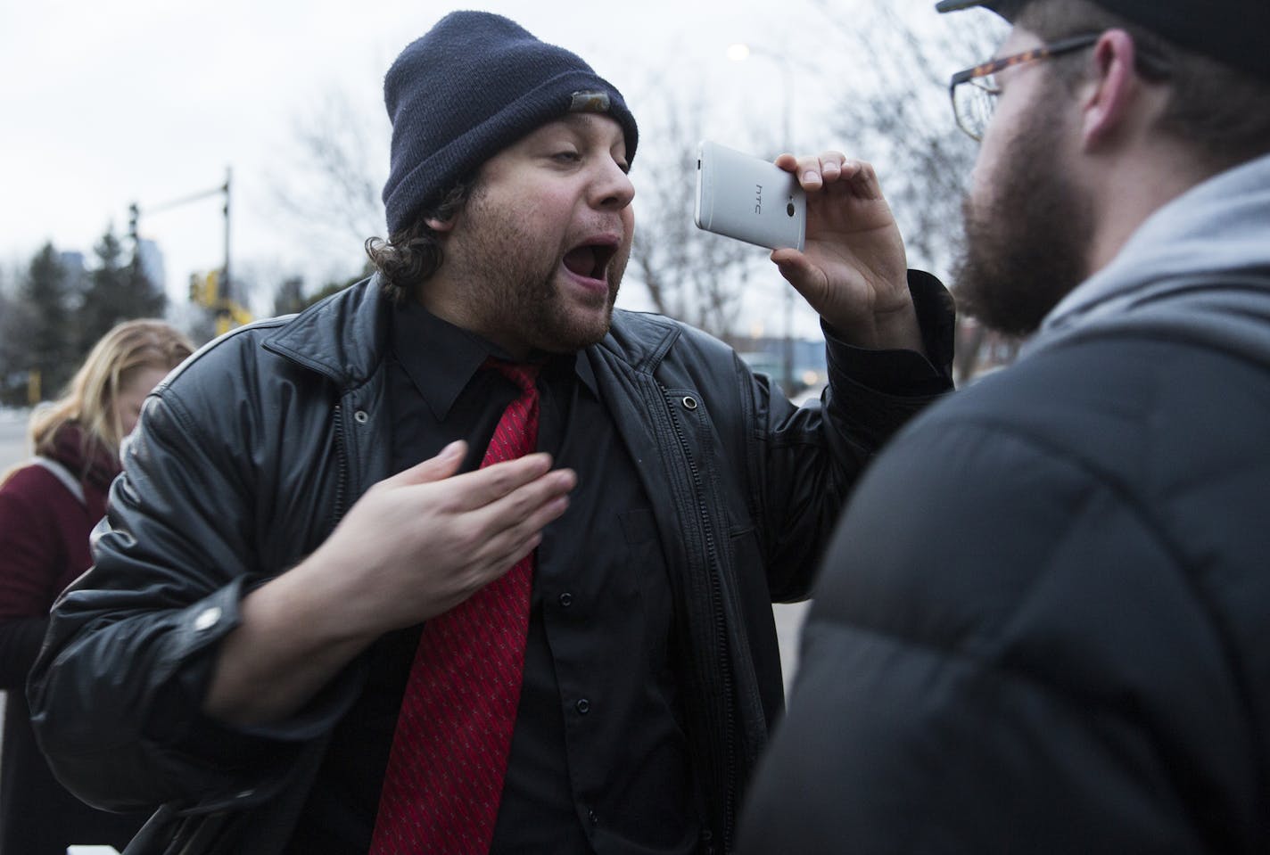 Martin Kiley Medved, left, a free speech advocate, interrupts a protest against Milo Yiannopoulos and Christina Hoff Sommers outside the Humphrey Institute of Public Affairs on the campus of the University of Minnesota in Minneapolis on Wednesday, February 17, 2016. The protester on the right, who was part of the protest against Milo Yiannopoulos and was trying to stop Medved from interrupting them, did not want to give his name. ] (Leila Navidi/Star Tribune) leila.navidi@startribune.com