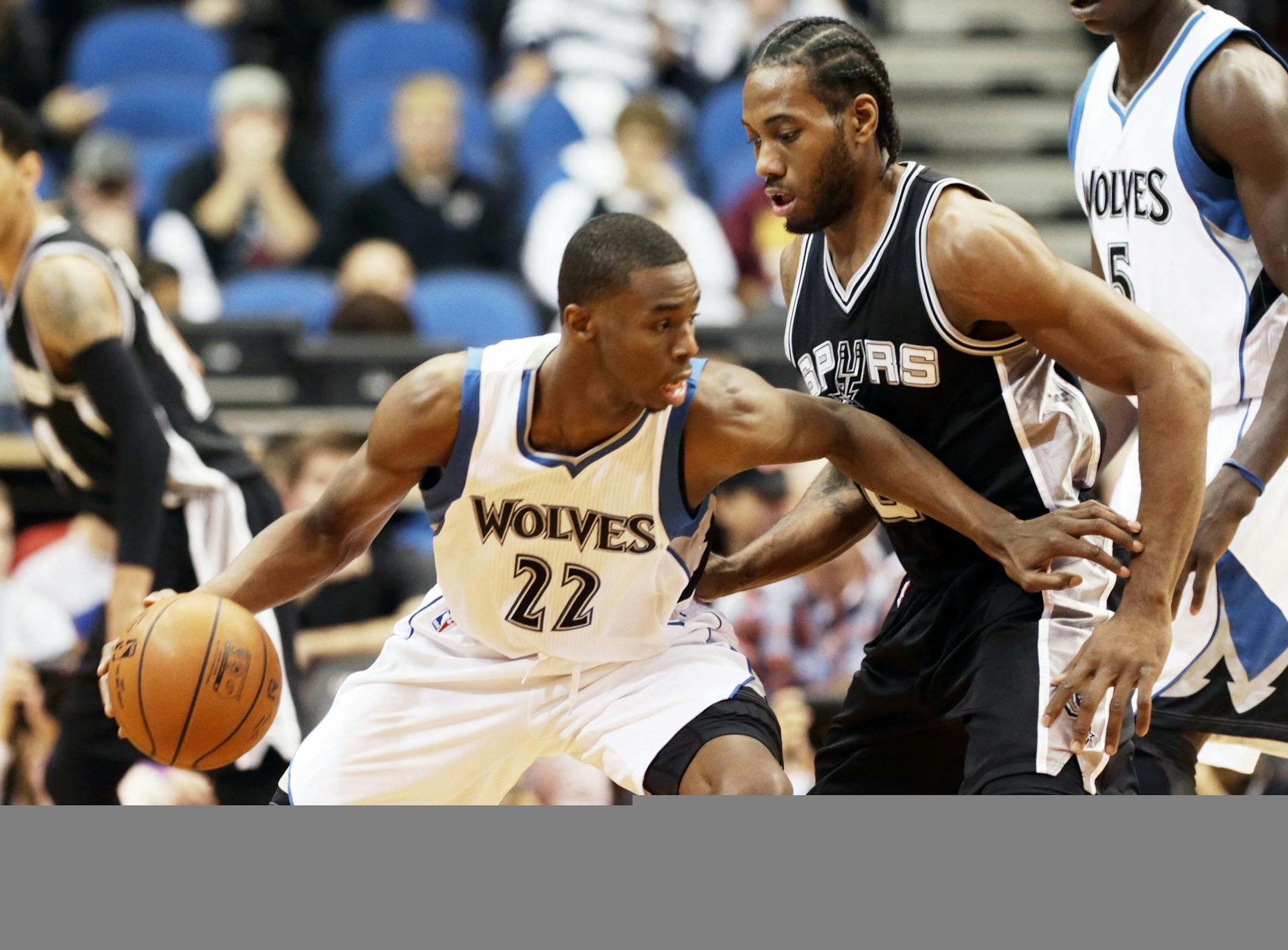 Minnesota Timberwolves� Andrew Wiggins, left, makes his way around San Antonio Spurs� Kawhi Leonard in the first quarter of an NBA basketball game, Friday, Nov. 21, 2014, in Minneapolis. The Spurs won 121-92.