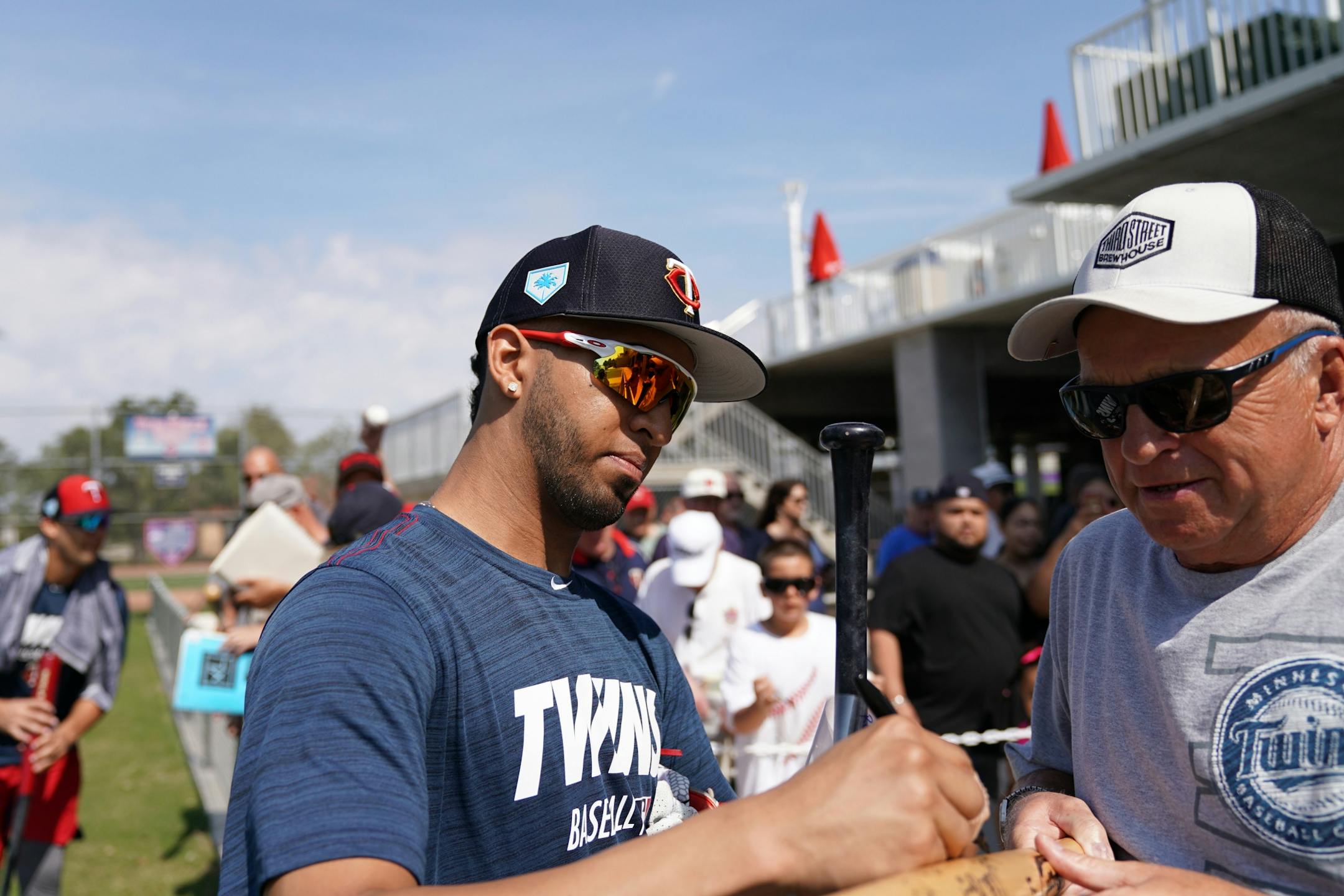 Minnesota Twins left fielder Eddie Rosario (20) signed an autograph for a fan after informal drills Saturday.