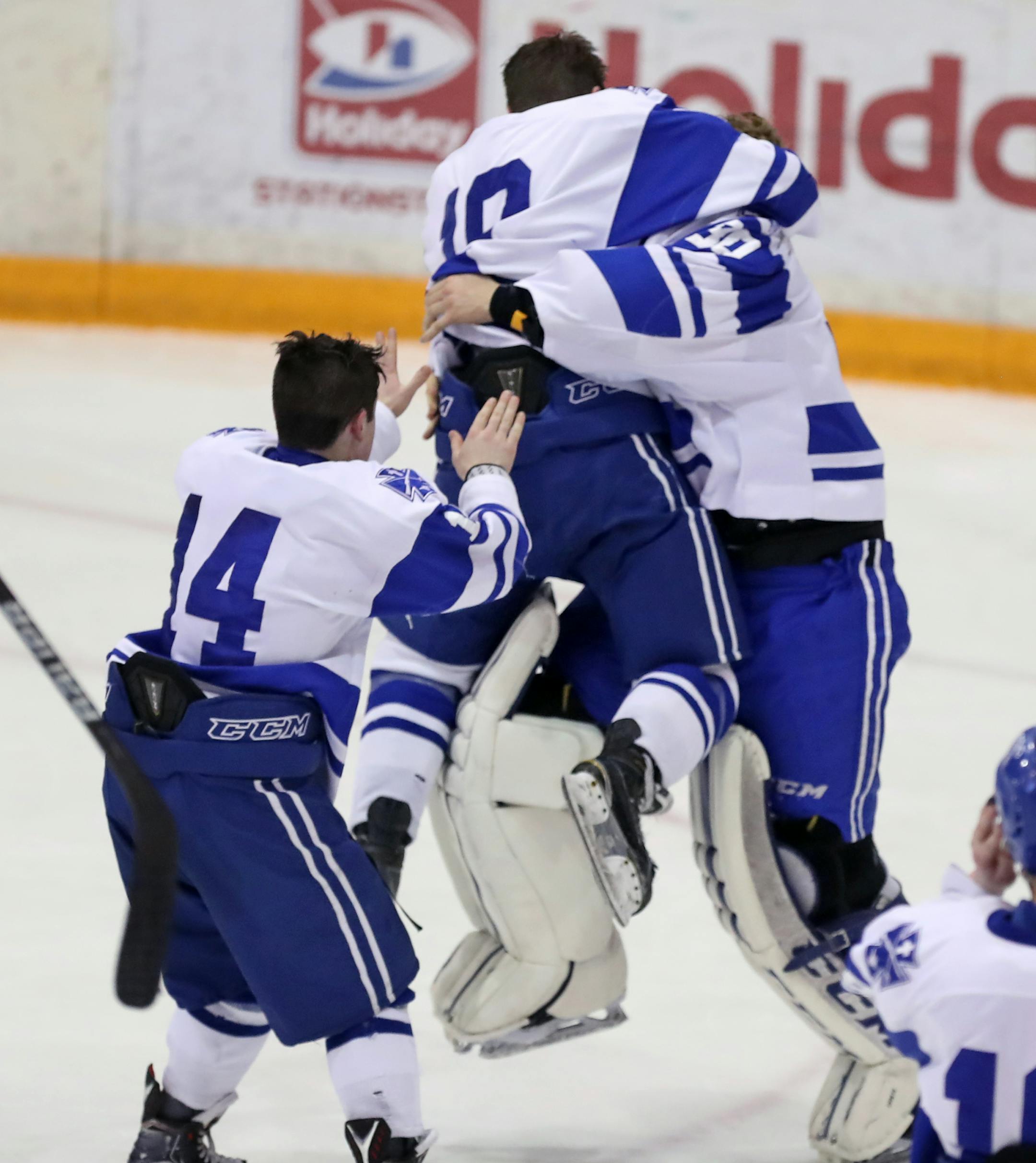 St. Thomas Academy celebrates its title by mugging the goalie Atticus Kelly(30.] In the #AA Championship game between Bloomington Jefferson and St. Thomas Academy at Ridder Arena on the U of M campus. RICHARD TSONG-TAATARII &#xef; richard.tsong-taatarii@startribune.com