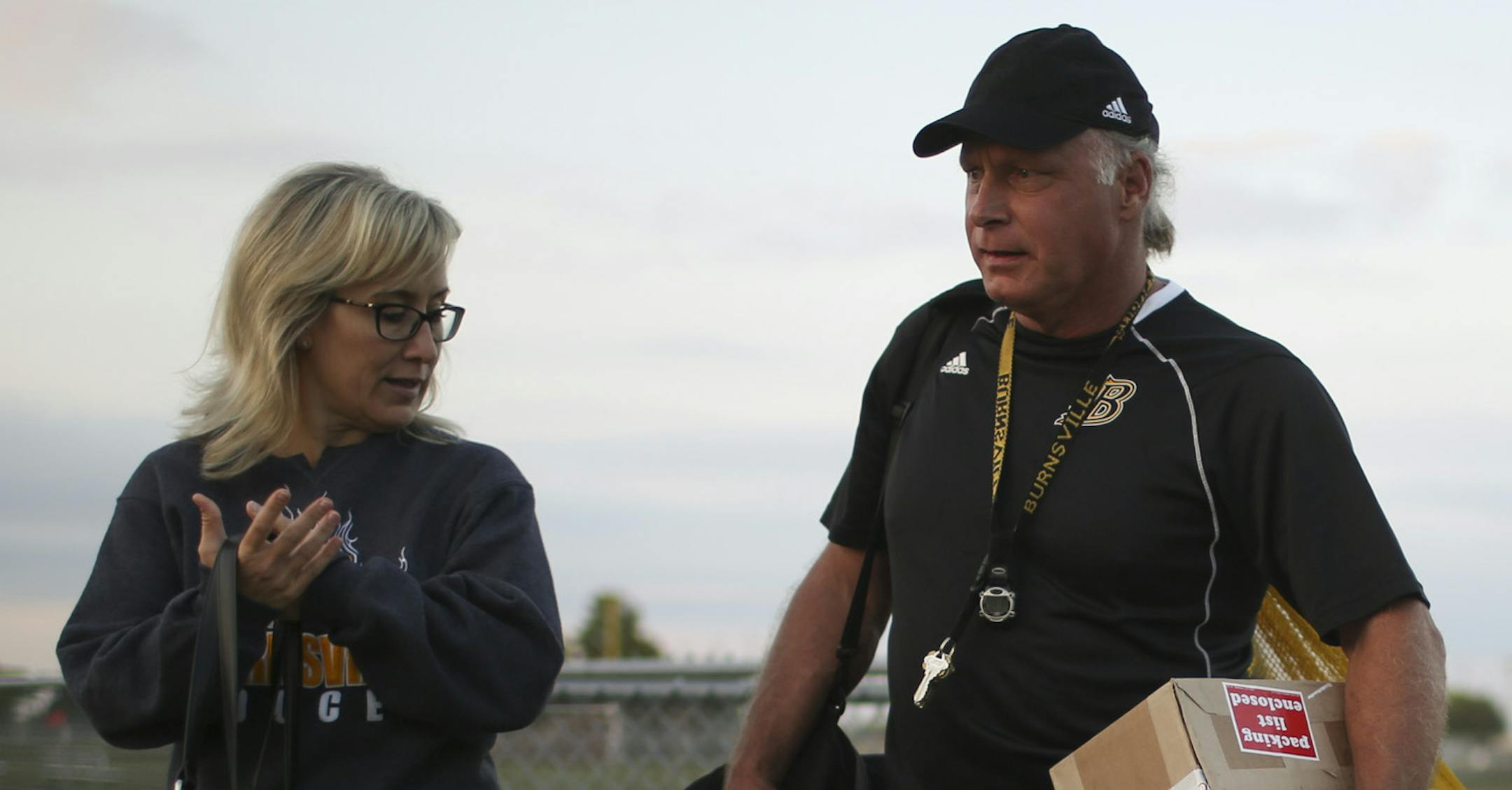 Burnsville girls' soccer coach John Soderholm is escorted by his wife Jenny after night games. “It’s a path we’re walking down together,” she said.