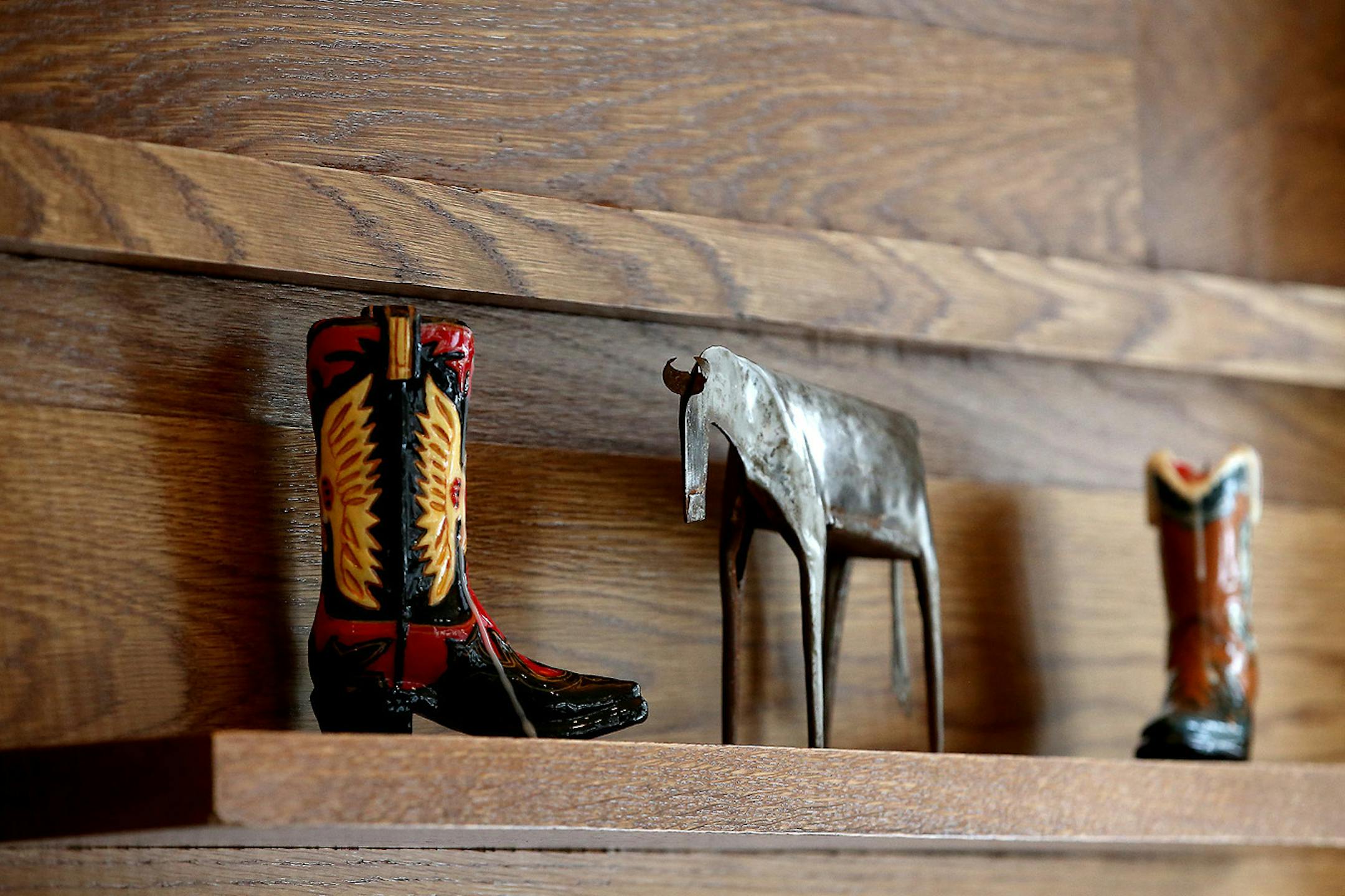 The feature wall includes staggered pieces of white oak that create display space for small collectibles.