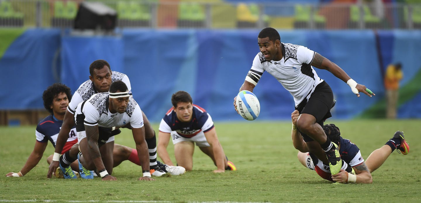 Samisoni Viriviri of Fiji powers toward the goal line in their men&#x2019;s rugby sevens pool play match against the United States, at the Summer Olympics in Rio de Janeiro, Aug. 10, 2016. Fiji won to advance to the quarterfinals; The American men were eliminated. (James Hill/The New York Times) -- NO SALES --