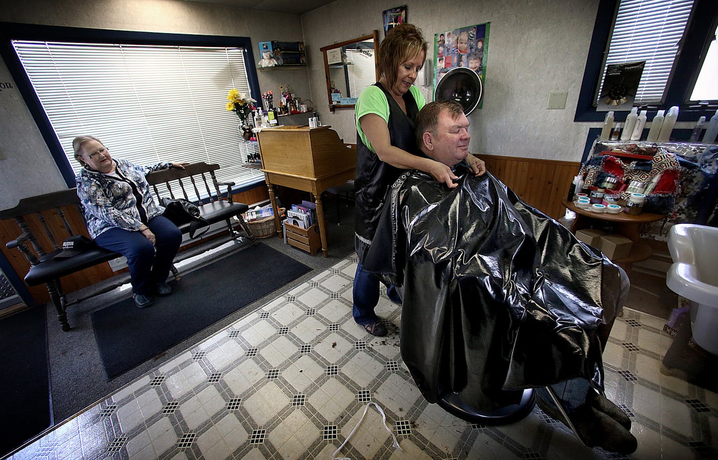 Sandi Wisness waited for her turn at Keene Kuts, where husband Paul Wisness was getting his haircut by Lisa Thompson. ] (JIM GEHRZ/STAR TRIBUNE) / October 23, 2013, Keene, ND &#x201a;&#xc4;&#xec; BACKGROUND INFORMATION- PHOTOS FOR USE IN SECOND PART OF NORTH DAKOTA OIL BOOM PROJECT: Rounding up of cattle and branding calves is a tradition handed down through generations of North Dakotans in the spring each year. Families take turns helping one another carry out the arduous, annual rite all over