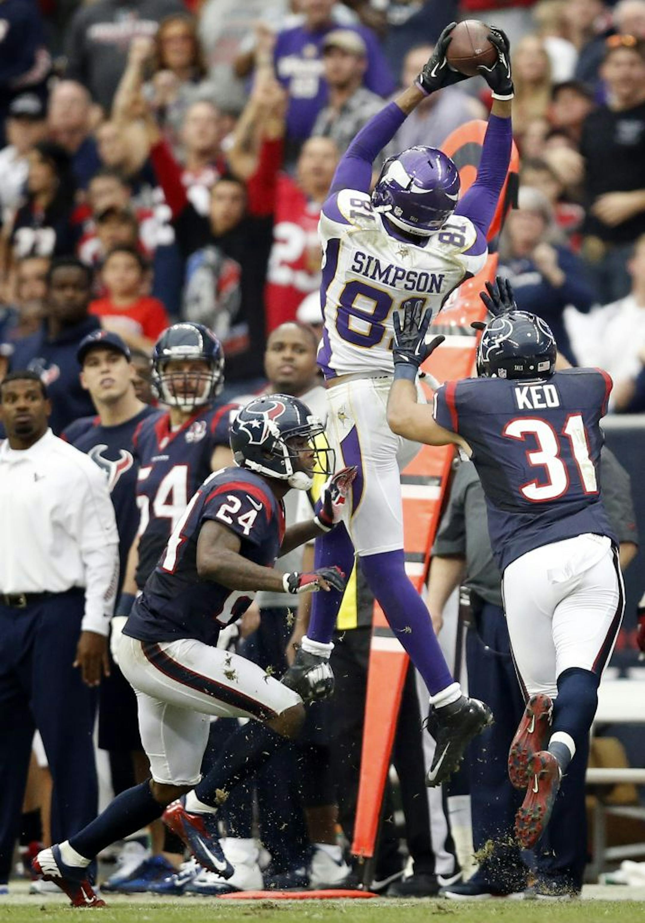 Vikings receiver Jerome Simpson (81) leapt over Houston defenders Johnathan Joseph (24) and Shiloh Keo (31) for a first down catch in the fourth quarter. Minnesota beat Houston by a final score of 23-6.
