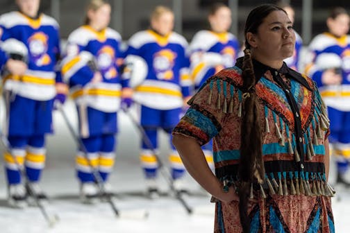 Meredith Two Crow pauses and listens to the Ojibwe drum circle during the Jan. 20 pregame ceremony.