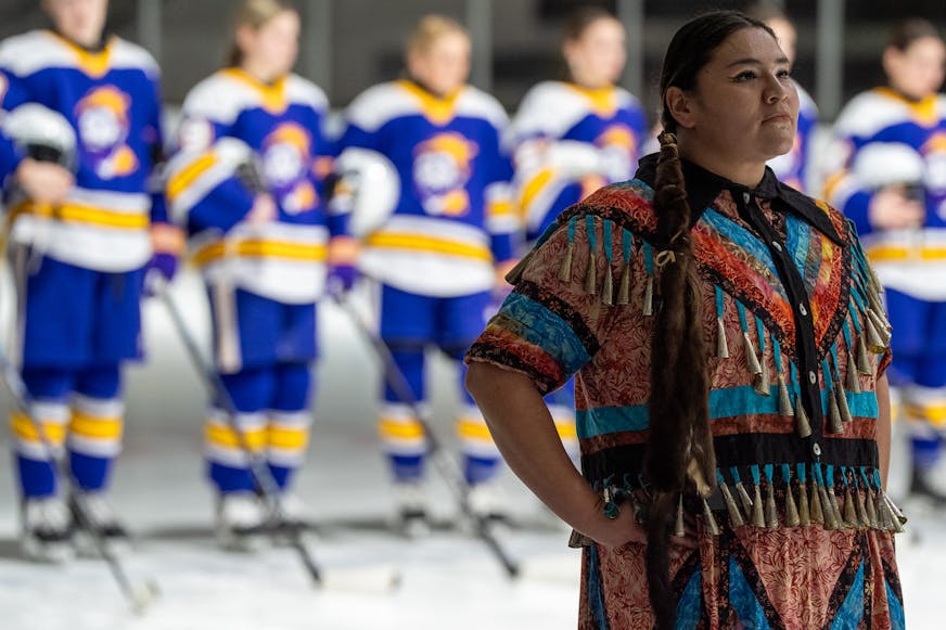Meredith Two Crow pauses and listens to the Ojibwe drum circle during the Jan. 20 pregame ceremony.