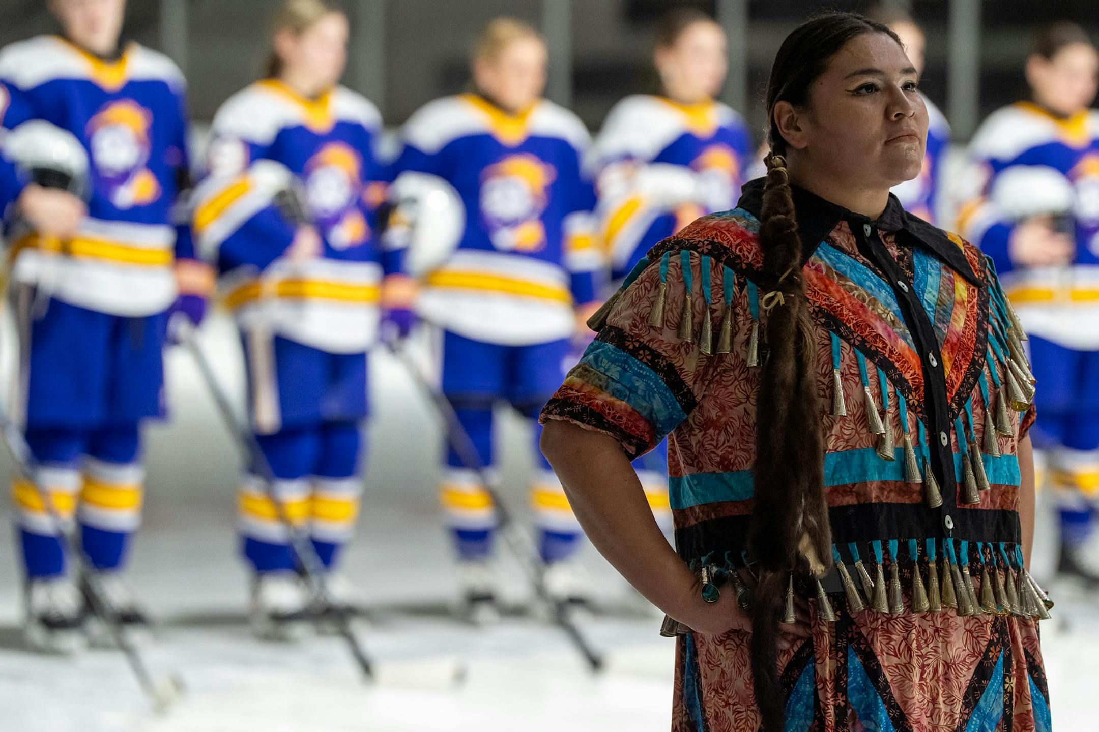 Meredith Two Crow pauses and listens to the Ojibwe drum circle during the Jan. 20 pregame ceremony.