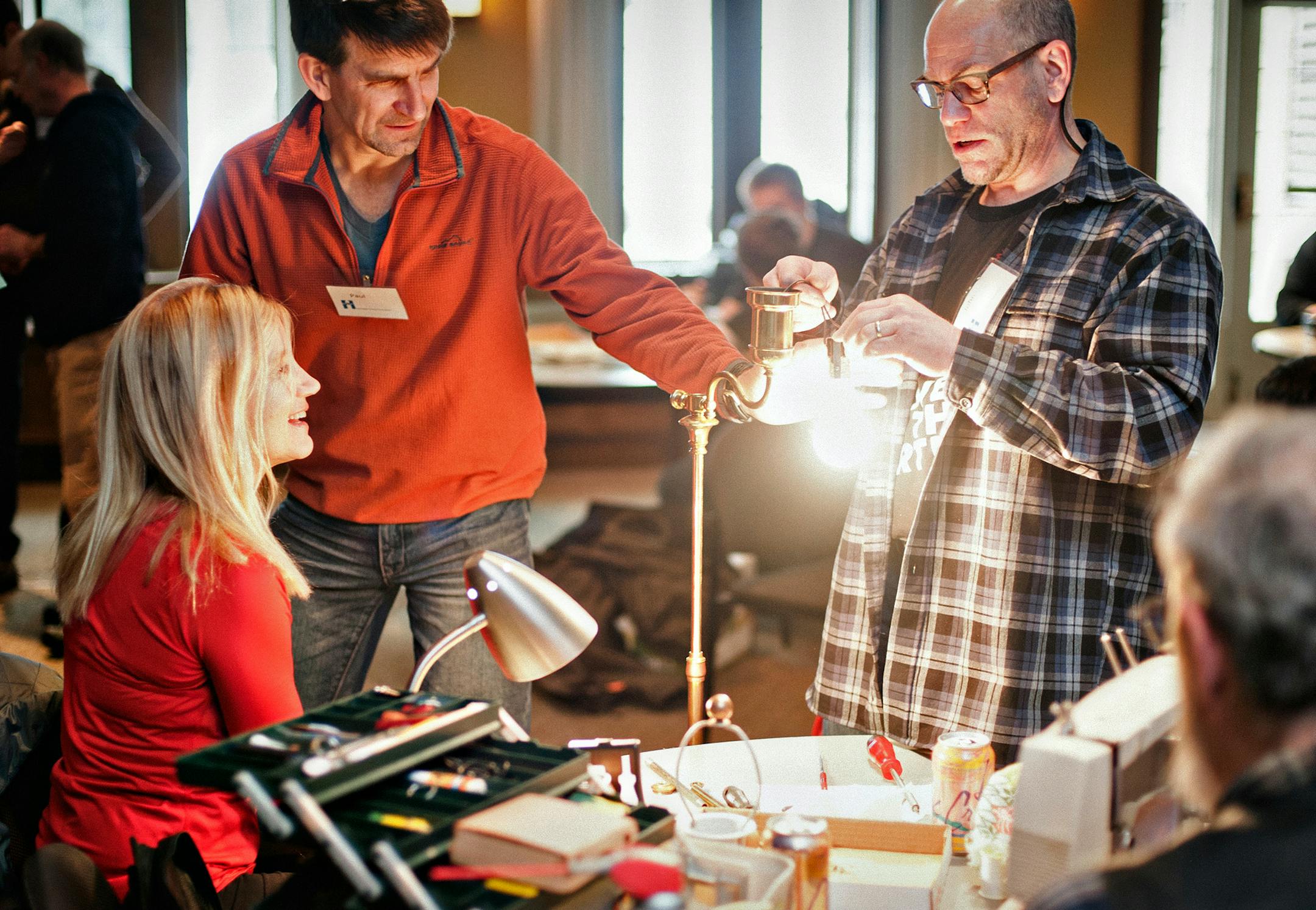 Several volunteers work on fixing a patron's broken lamp at the Fix It Clinic at the Bakken Museum in Minneapolis on January 11, 2014. ] Photo by Leslie Plesser / Star Tribune