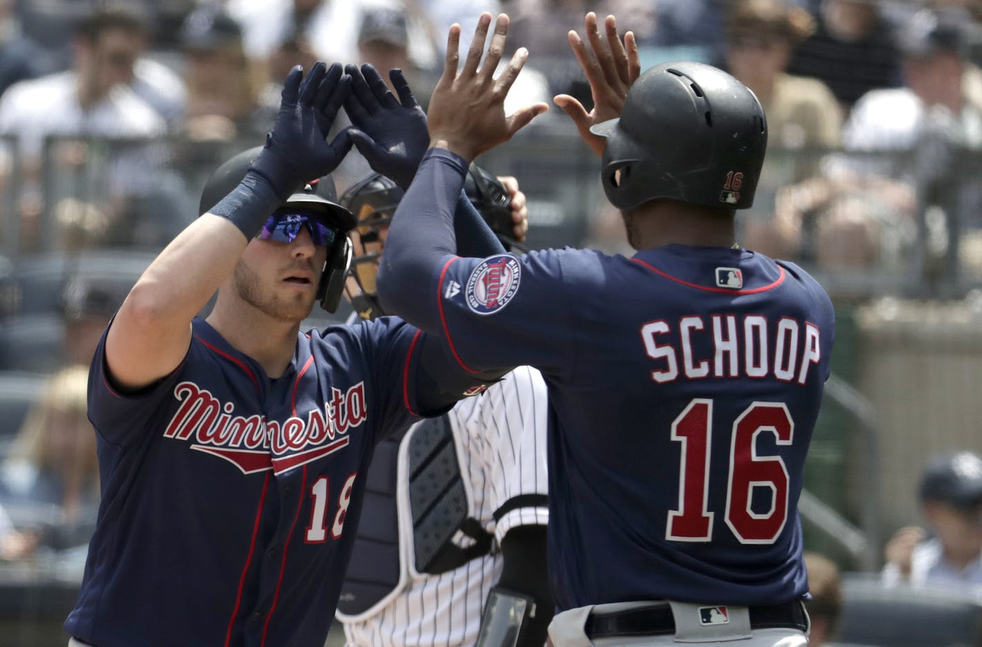 Mitch Garver is greeted at home plate by Jonathan Schoop in May at Yankee Stadium.