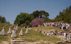 Visitors watch the performers, who will take part in the flame lighting ceremony for the Paris Olympics, during a rehearsal at Ancient Olympia site, G