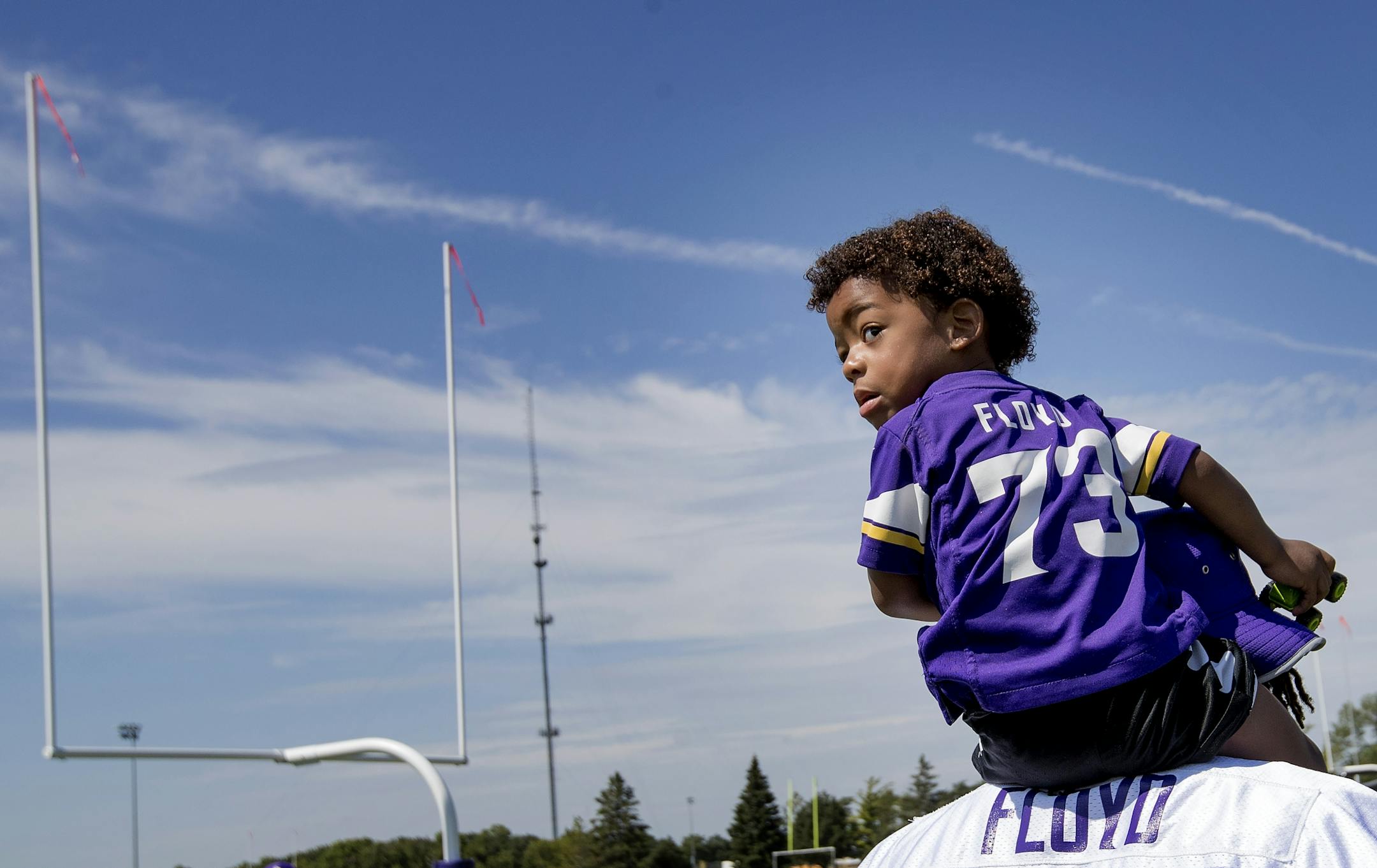 Minnesota Vikings defensive lineman Sharrif Floyd (73) carried his son Trygg, 3, at the end of the morning practice.
